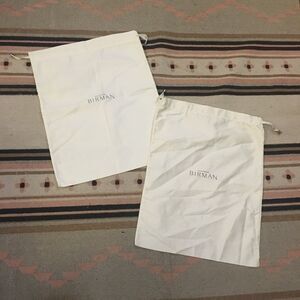 Two (2) Alexandre Birman soft white drawstring Dustbag 16” x 8”
Garment